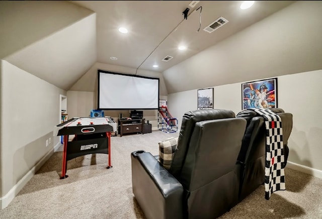 cinema with lofted ceiling and light carpet