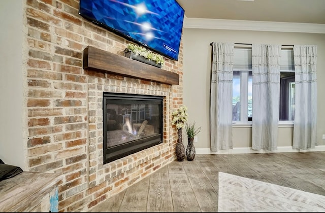 unfurnished living room with a fireplace, ornamental molding, and hardwood / wood-style flooring