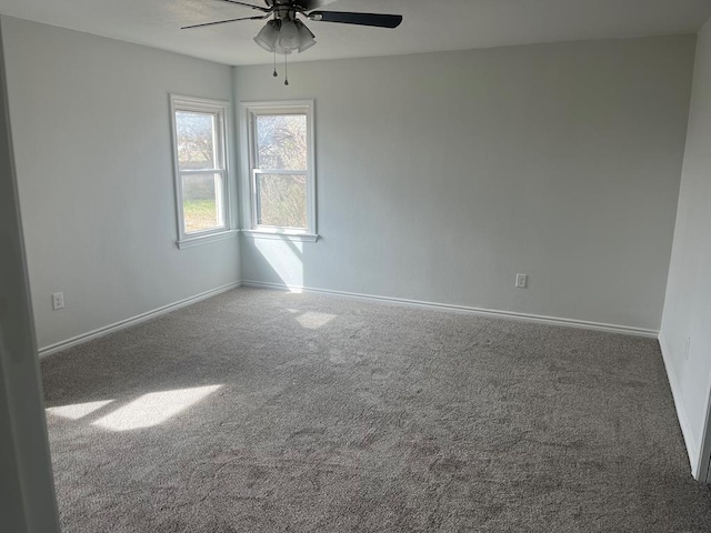 empty room featuring carpet flooring and ceiling fan