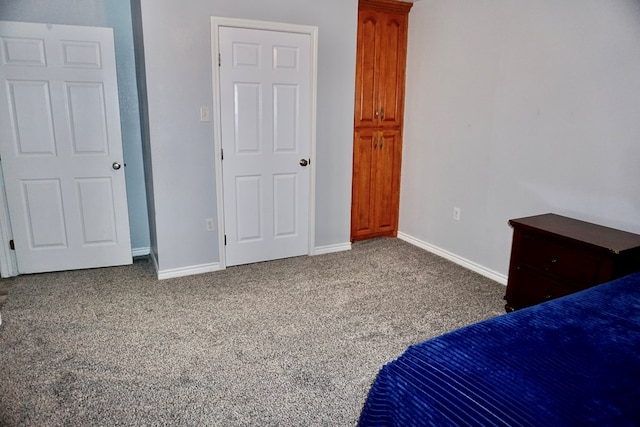 unfurnished bedroom with carpet floors and baseboards