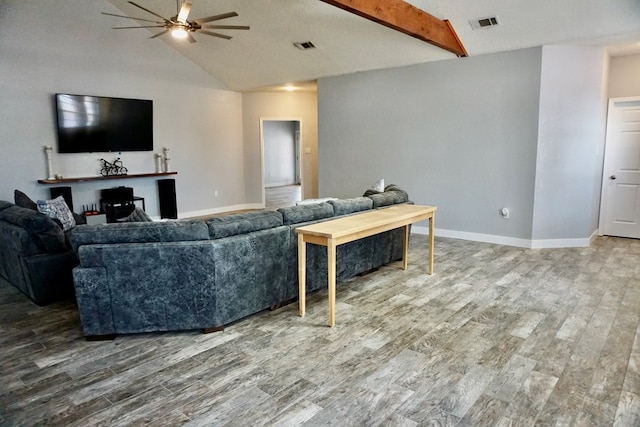 living room with baseboards, ceiling fan, wood finished floors, and lofted ceiling