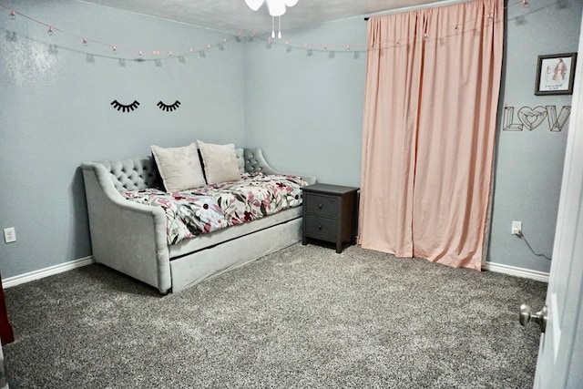 bedroom with baseboards and carpet