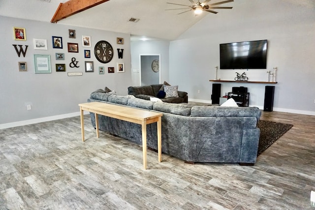 living room with ceiling fan, visible vents, wood finished floors, baseboards, and lofted ceiling