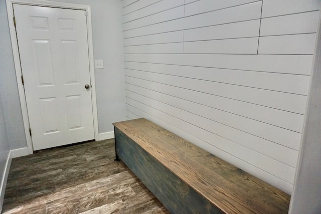 mudroom with wooden walls, baseboards, and dark wood finished floors