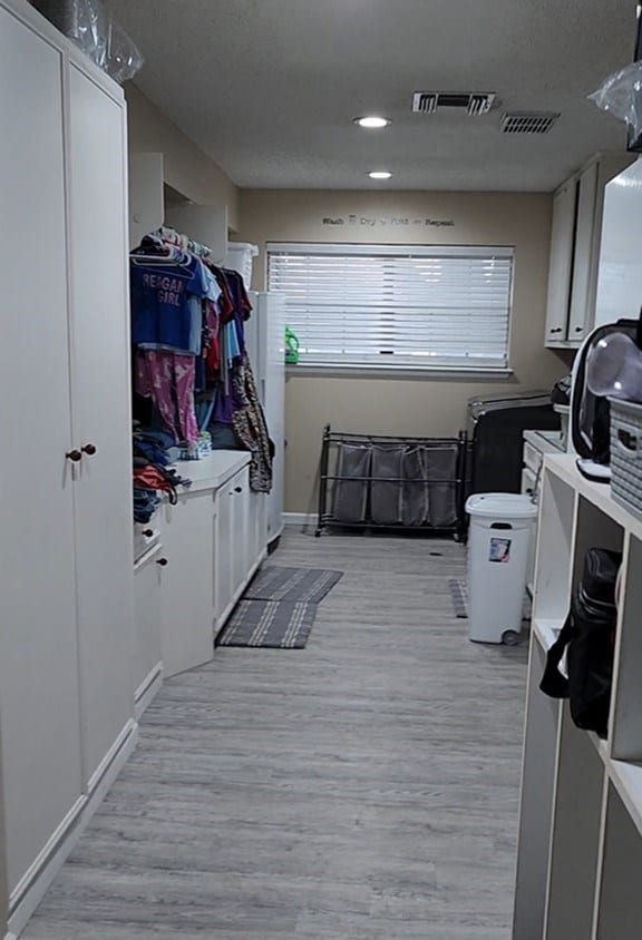 laundry area with light wood-type flooring