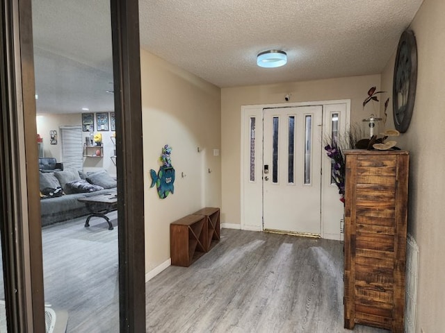 entrance foyer with wood-type flooring and a textured ceiling