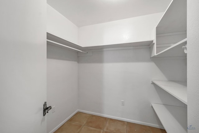 walk in closet featuring tile patterned flooring