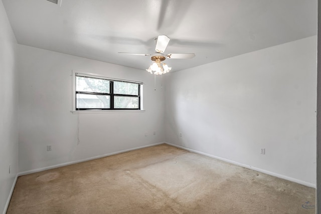 empty room with ceiling fan and light colored carpet