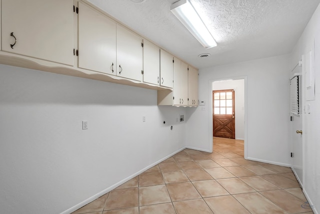 clothes washing area with cabinets, hookup for a gas dryer, hookup for a washing machine, hookup for an electric dryer, and light tile patterned flooring