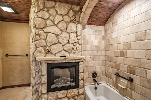 bathroom featuring a fireplace, vaulted ceiling, shower / washtub combination, and wood ceiling