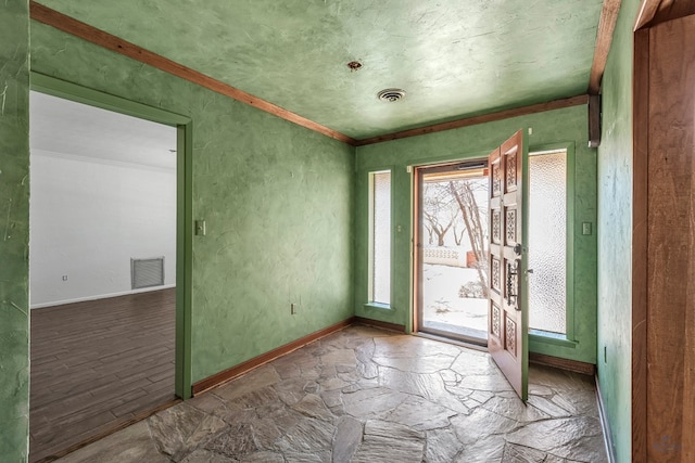 empty room featuring crown molding and wood-type flooring