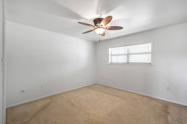 empty room with ceiling fan and light colored carpet