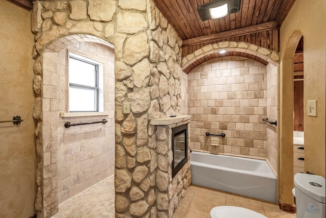 bathroom featuring toilet, wooden ceiling, and a tub