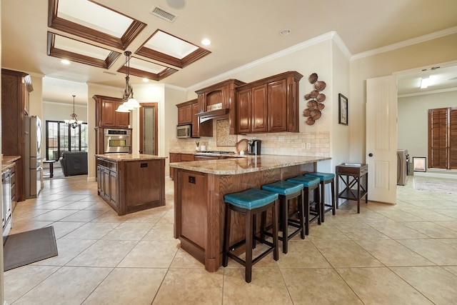 kitchen featuring crown molding, appliances with stainless steel finishes, tasteful backsplash, light stone counters, and kitchen peninsula