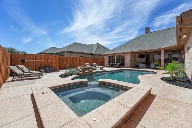 view of swimming pool featuring an in ground hot tub and a patio