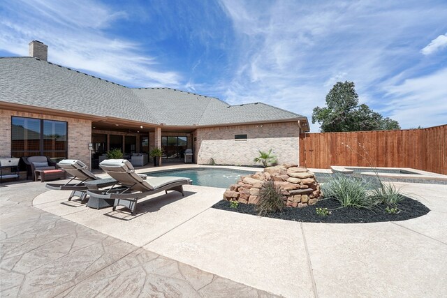 view of pool featuring an in ground hot tub and a patio area