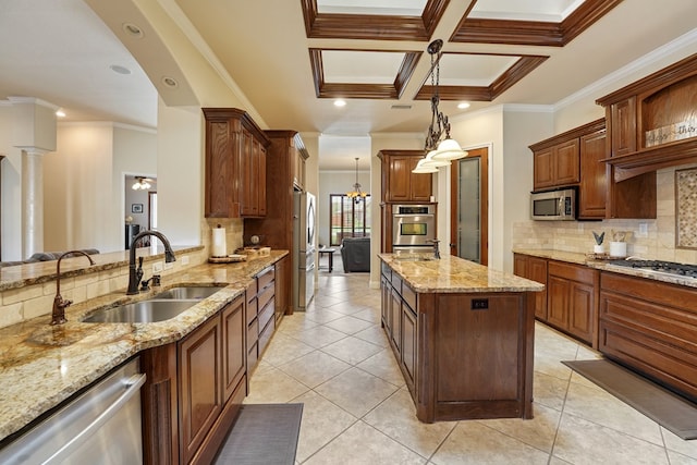 kitchen with stainless steel appliances, hanging light fixtures, crown molding, and sink