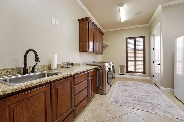 laundry area with crown molding, cabinets, sink, and washing machine and clothes dryer