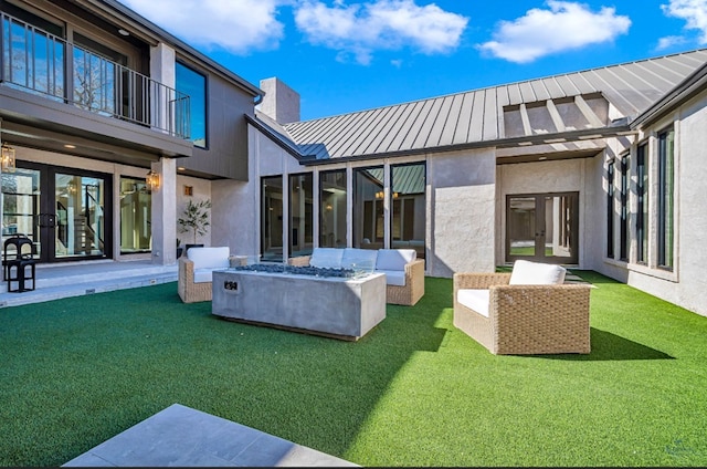 rear view of property featuring an outdoor hangout area, french doors, and a lawn