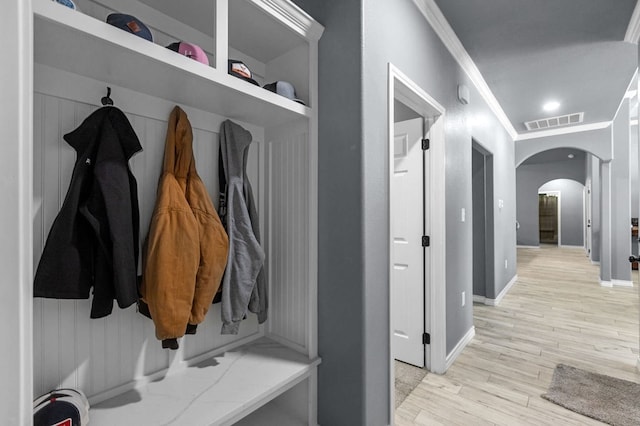 mudroom featuring crown molding and light wood-type flooring