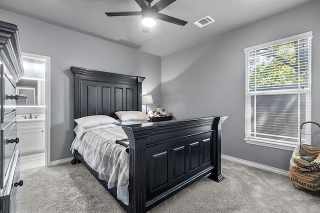 carpeted bedroom featuring connected bathroom, ceiling fan, and sink