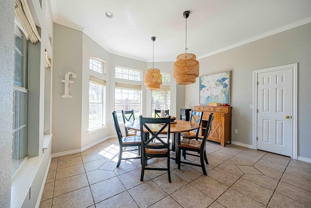 dining room featuring crown molding and light tile patterned flooring