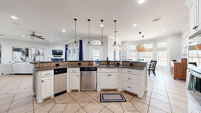 kitchen with white cabinets, stainless steel dishwasher, and a kitchen island