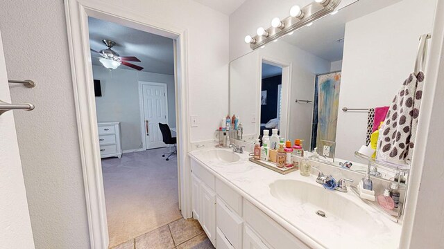 bathroom with tile patterned floors, vanity, and ceiling fan