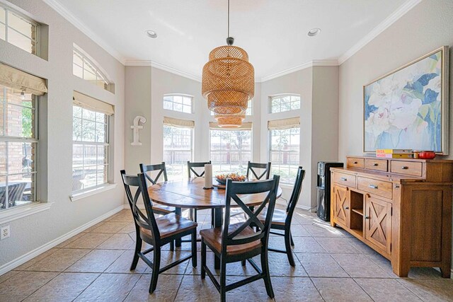 tiled dining room featuring crown molding, plenty of natural light, and a notable chandelier