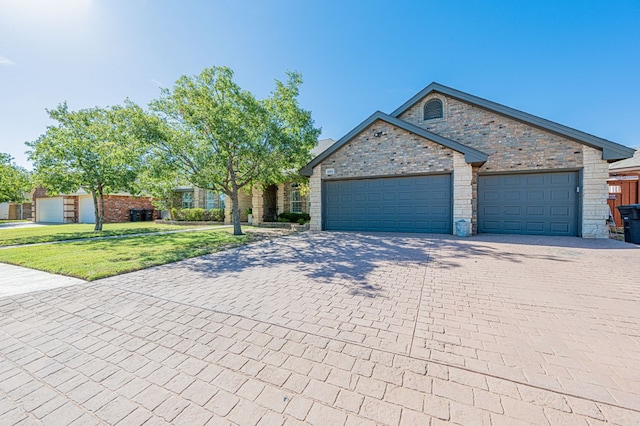 view of front of home with a garage and a front yard