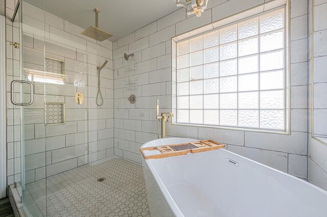 bathroom with plus walk in shower and tile walls