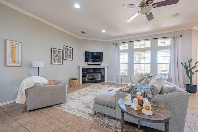 living room with light tile patterned floors, ceiling fan, and crown molding