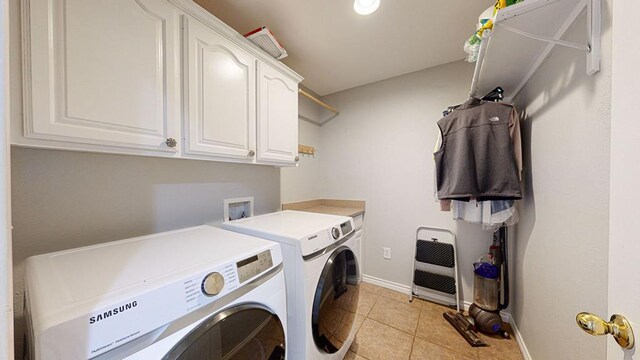 clothes washing area featuring light tile patterned flooring, cabinets, washing machine and dryer, and heating unit