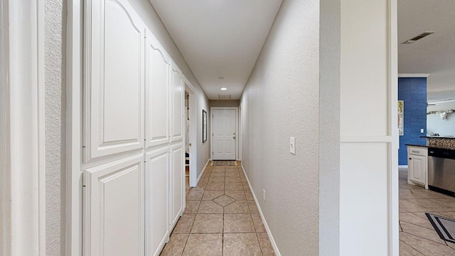 corridor featuring light tile patterned floors