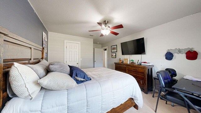 bedroom featuring light colored carpet and ceiling fan