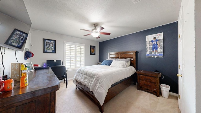 carpeted bedroom with a textured ceiling and ceiling fan