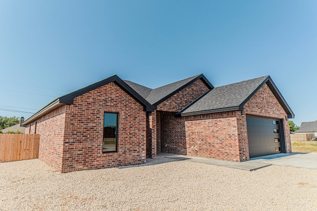 1708 E Main St, Brownfield, TX 79316 - view of front of property with brick siding, roof with shingles, concrete driveway, and an attached garage