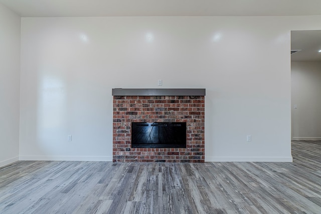 1708 E Main St, Brownfield, TX 79316 - detailed view of wood finished floors, baseboards, and a fireplace
