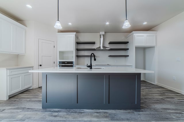 1708 E Main St, Brownfield, TX 79316 - kitchen with open shelves, a sink, wall chimney range hood, white cabinets, and recessed lighting