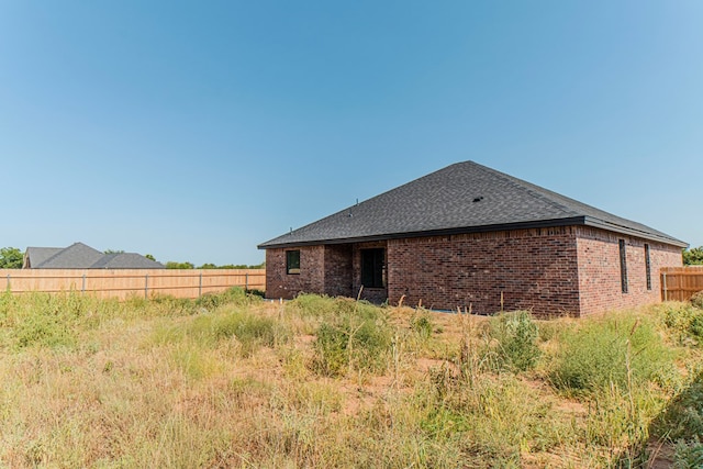 1708 E Main St, Brownfield, TX 79316 - rear view of house featuring roof with shingles and brick siding