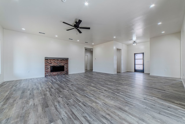 1708 E Main St, Brownfield, TX 79316 - unfurnished living room with wood finished floors, ceiling fan, a fireplace, recessed lighting, and baseboards