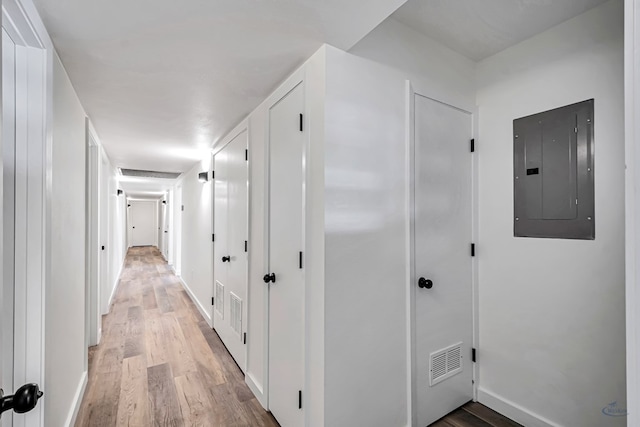 905 Mountain Park Dr, Big Spring, TX 79720 - hallway featuring electric panel, light wood-style floors, and baseboards