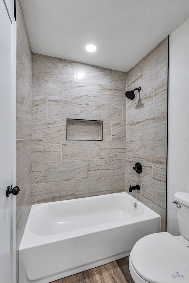 905 Mountain Park Dr, Big Spring, TX 79720 - bathroom with toilet, wood finished floors, and bathing tub / shower combination