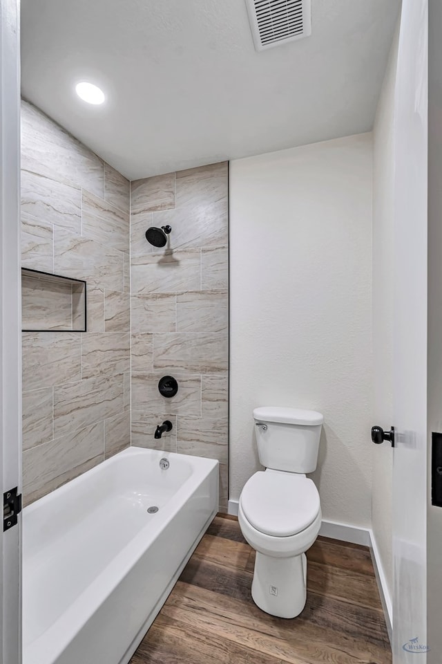905 Mountain Park Dr, Big Spring, TX 79720 - bathroom with baseboards, wood finished floors, toilet, and shower / bath combination