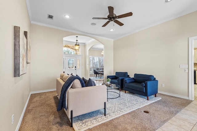 tiled living room featuring ornamental molding and ceiling fan