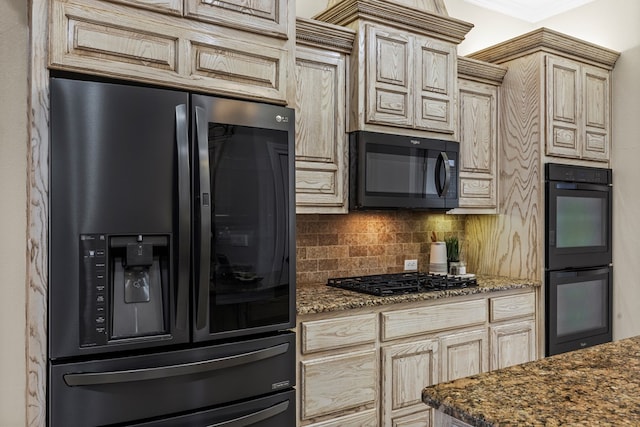 kitchen featuring tasteful backsplash, dark stone countertops, light brown cabinets, and black appliances