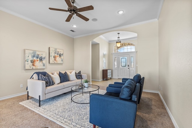 living room with ornamental molding, carpet flooring, and ceiling fan