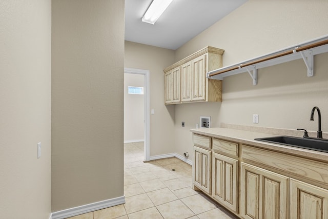 clothes washing area with sink, light tile patterned floors, cabinets, washer hookup, and hookup for an electric dryer