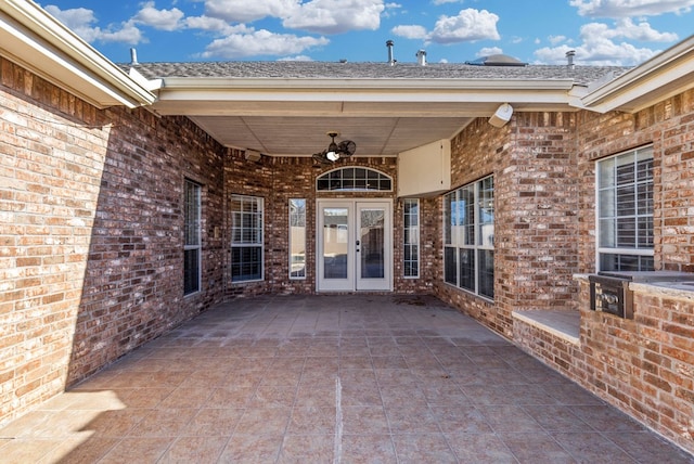 entrance to property with a patio, ceiling fan, and french doors