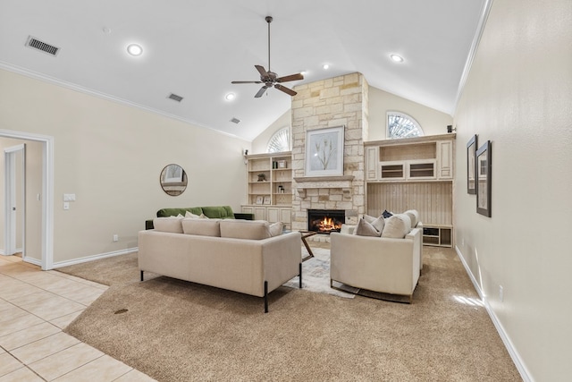 tiled living room with ceiling fan, ornamental molding, a fireplace, and high vaulted ceiling